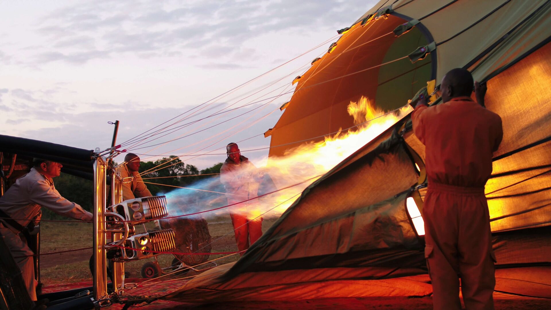 Hot-air balloon drifting above the Mara at sunrise