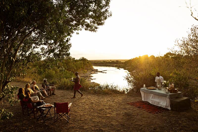 Drinks by the river as the sun goes down, the bar table laid