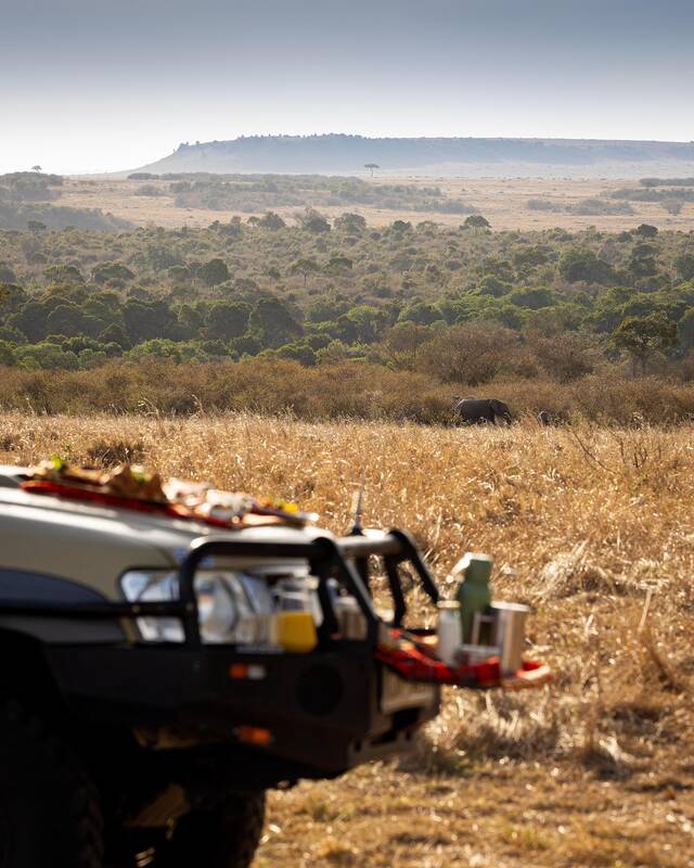Breakfast laid on the bonnet, the Mara spread out below