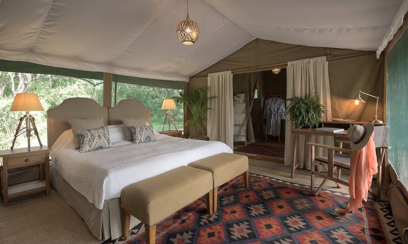 Family suite — the parents' tent with king bed, kilim rugs and a writing desk