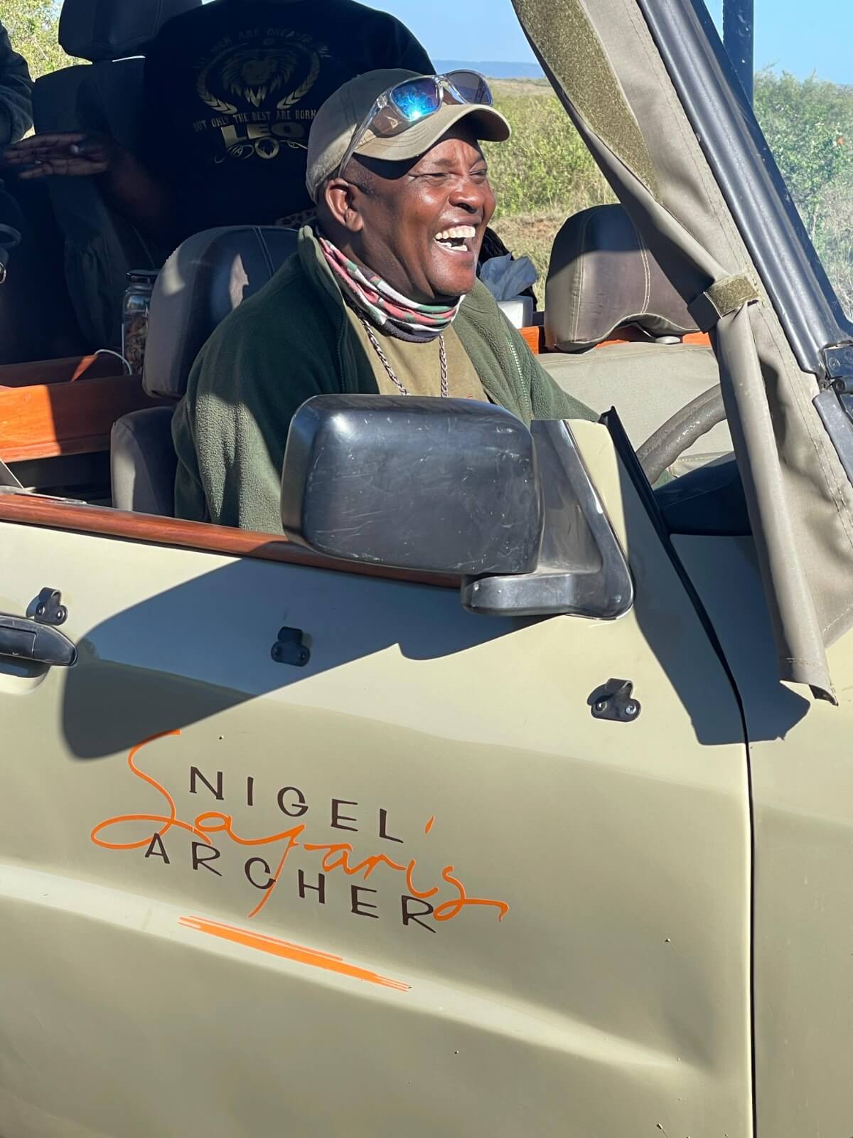 Lolo, Head Guide, laughing in a safari vehicle